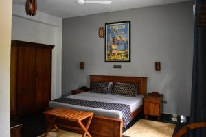 a bedroom with a bed and a picture on the wall at BREATHE Collections Habaraduwa in Habaraduwa