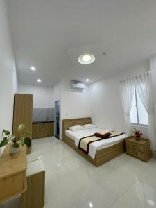 a bedroom with a bed in a room at LAKSHMI Apartment & Hotel Da Nang in Danang