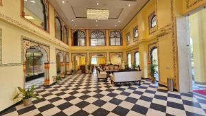 a lobby of a building with a checkered floor at Hotel Ranavilas Palace in Jaipur