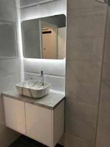 a bathroom with a sink and a mirror at Studio Vučko in Pale
