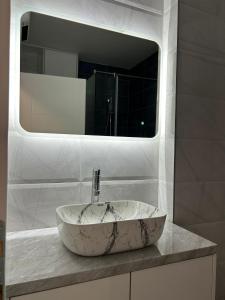 a bathroom with a marble sink and a mirror at Studio Vučko in Pale