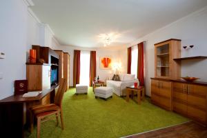 een woonkamer met een bank en een tv in een kamer bij Parkvilla Appartements in Bad Hofgastein