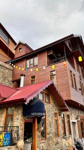 a building with a santa barbara sign in front of it at Isgobya Sumela Monastery 102 in Macka +21 photos