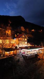 a large building with lights on at night at Isgobya Sumela Monastery 102 in Macka