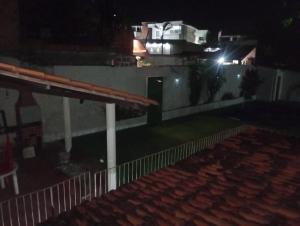 a night view of a house with a light on the roof at Recanto do alberto in Camacari