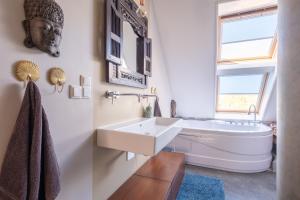 a bathroom with a sink and a bath tub at LOFT Groepsaccommodatie in Boksum +89 photos