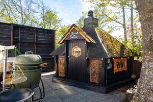 a small black dog house sitting on a patio at LOFT Groepsaccommodatie in Boksum
