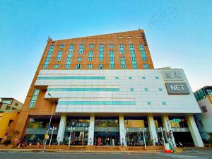 a building with a sign on the front of it at Wemeet Hotel in Pingtung City