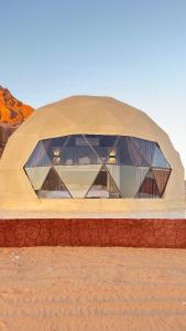 a large dome building in the middle of the desert at Tariq Camp Wadi Rum in Wadi Rum