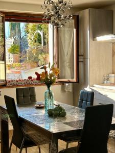 a dining room table with a vase of flowers on it at Relax Home Holiday in Panicale