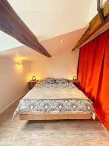 a bedroom with a bed with a red curtain at Coeur Rochelais, Atypique, centre, 5 min du port in La Rochelle