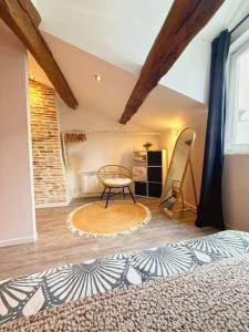 a bedroom with a bed and a chair in a room at Coeur Rochelais, Atypique, centre, 5 min du port in La Rochelle +8 photos