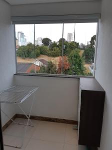 a window in a room with a table in front of it at Kitnet acolhedora in Caxias do Sul