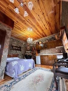 a bedroom with a bed and a wooden ceiling at Isgobya Sumela Monastery 104 in Macka