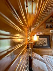 a bed in a room with a ceiling with a lamp at Isgobya Sumela Monastery 104 in Macka