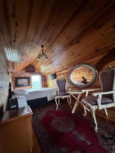 a bedroom with a bed and a table and chairs at Isgobya Sumela Monastery 104 in Macka