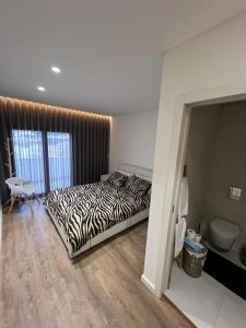 En eller flere senge i et værelse på Apartamento T2 - Leiria