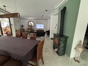 a living room with a fireplace and a table and a stove at Willa Marie in Krynica Zdrój