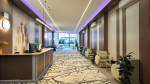 an office lobby with a reception desk and chairs at نوف بلازا nouf plaza for serviced apartments in Ad Dawādimī