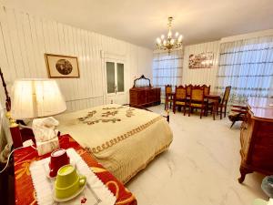 a bedroom with a bed and a table and chairs at L'ENCANTO DE LUNA -Una Casa Autentica Comacchiese in Comacchio