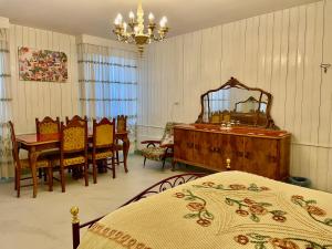 a bedroom with a bed and a table and a mirror at L'ENCANTO DE LUNA -Una Casa Autentica Comacchiese in Comacchio +49 photos