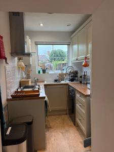 a kitchen with a sink and a counter top at 2 Bed Terrace Cottage with Cathedral Views in Salisbury