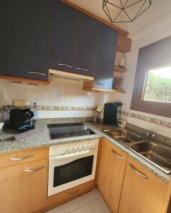 a kitchen with a sink and a stove top oven at Anchoveta in Calonge