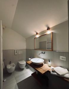 a bathroom with a sink and a toilet and a mirror at La Barchessa in Corva +166 photos