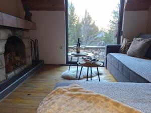 a living room with a couch and a fireplace at Planinska Kućica in Mostar