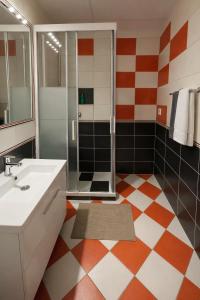 a bathroom with a white sink and a shower at 3BR near Center with Parking in Bratislava