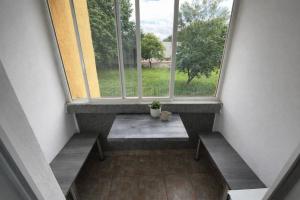 a room with two benches and a large window at 3BR near Center with Parking in Bratislava