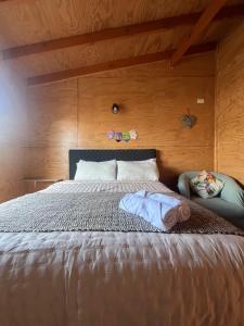 En eller flere senge i et værelse på Departamentos NuBe1 Castro Chiloé