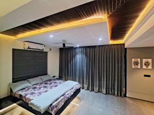 a bedroom with a bed and a large window at Luxe poolside farmhouse -J House in Hyderabad +8 photos
