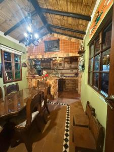 a kitchen with a table and chairs and a counter at Monguí Posada Familiar in Duitama