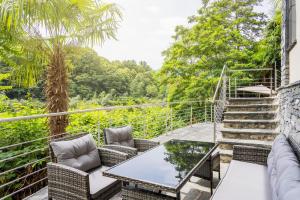 a patio with chairs and a table and stairs at Casa Magging un oasi nel verde in Locarno