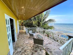 a balcony of a house with a view of the ocean at Casa Vista al Amatique in Puerto Barrios