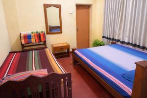 En eller flere senge i et værelse på Yashora Gimanhala