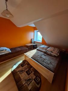 a small room with two beds and a window at Atticapartament in Kluszkowce +1 photo