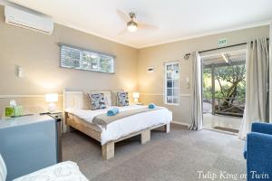 a bedroom with a bed and a sliding glass door at Five Mountains Guest Farm & Spa in Wellington +57 photos