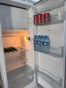 een open koelkast met flessen water en frisdrank bij Ofurô com hidromassagem aquecida in Guia Lopes da Laguna +26 foto's