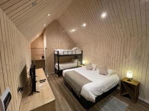 a bedroom with a bed in a small room at Hotel Puerto Madera in Pelluhue