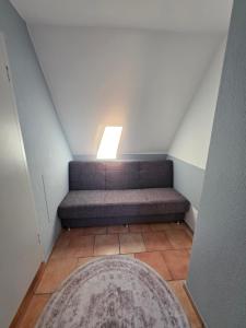 a stairway with a bench with a window and a rug at Fewo LucGa in Zingst