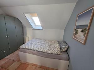 a small bedroom with a bed in a attic at Fewo LucGa in Zingst