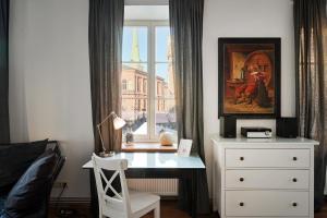 a bedroom with a desk in front of a window at Haffelberg House in Riga