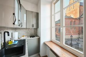 a kitchen with a sink and a window at Haffelberg House in Riga