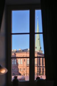 a window with a view of a building and a tower at Haffelberg House in Riga
