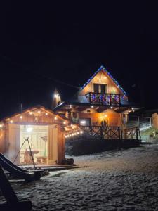 a house with lights on it at night at Domek w dolinie ciszy Pieniny in Grywałd
