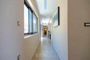 a hallway with windows and a table in a room at Lamar Private Luxury Villas in Marathias