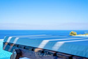 een afbeelding van een blauw matras op een strand bij Lamar Private Luxury Villas in Marathias