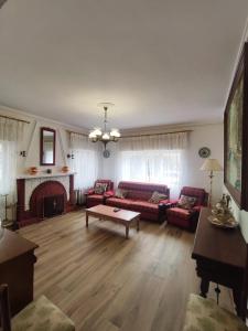 a living room with red couches and a fireplace at Casa Rural Angorrilla in Reolid +16 photos